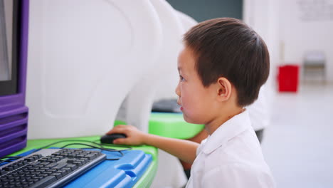 Asian schoolboy using computer at a science activity centre