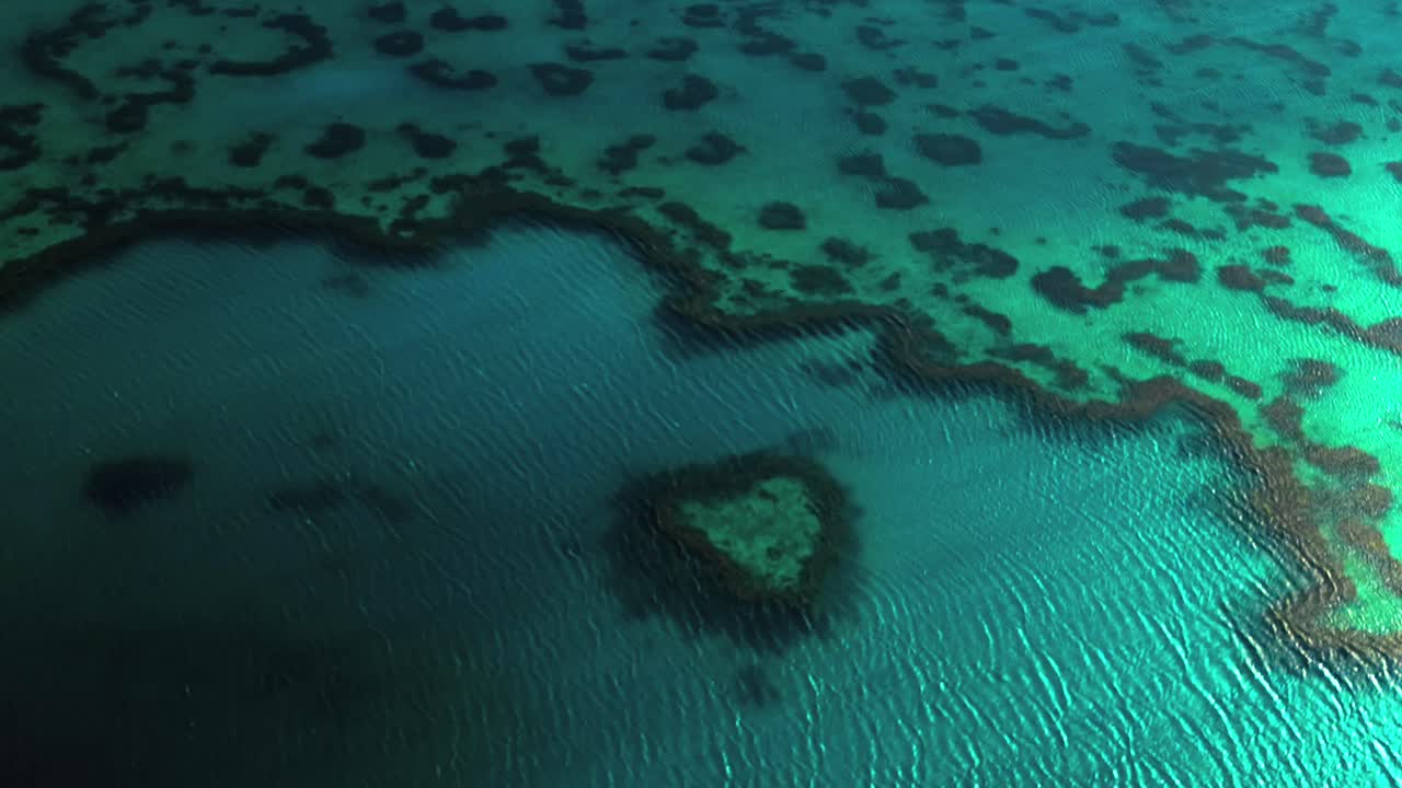 Heart Reef Hardy Outer Great Barrier Reef lagoon Whitsundays scenic flight aerial drone Whitsundays Islands Australia QLD National Park sunny serene coral formation clouds clear blue aqua ocean waters