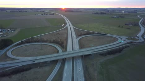 aerial view of freeway intersection with moving traffic cars.