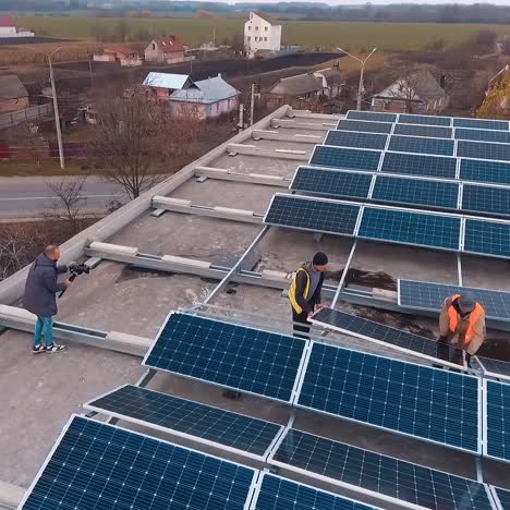 solar panels installation on the top of building. workers put new solar battery on roof. renewable energy from the sun. aerial view.
