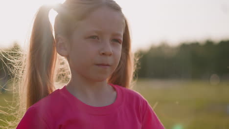 unhappy girl with swollen eyelid stands in green field