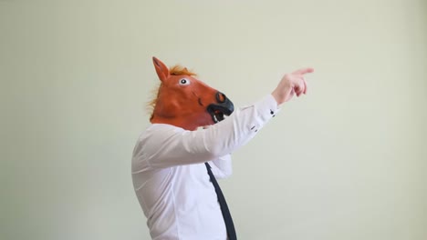 a man in a horse mask dances looking at the camera a man in a horse mask dances looking at the camera