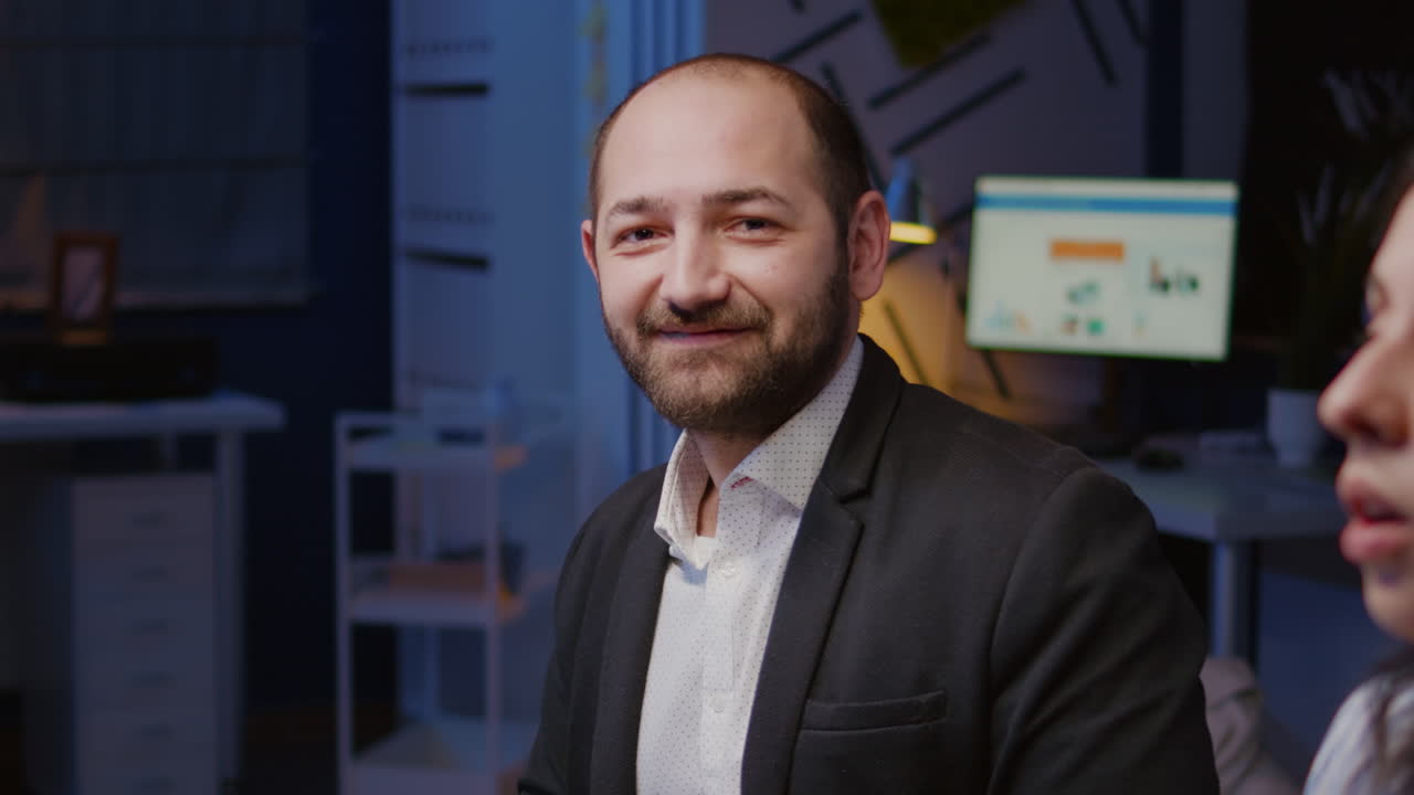 Portrait of smiling businessman looking into camera working at company strategy