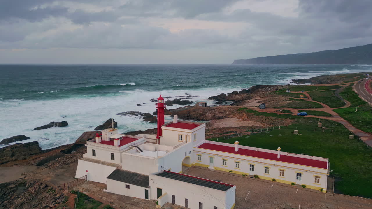 Drone beacon standing coastline cloudy evening. Red lighthouse at ocean shore