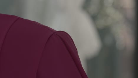 close up of a woman, seen from behind, appears to be preoccupied with her tablet at home