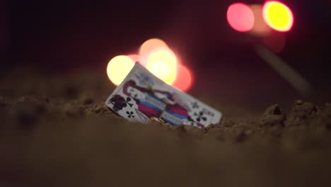 lost playing card in the ground at night