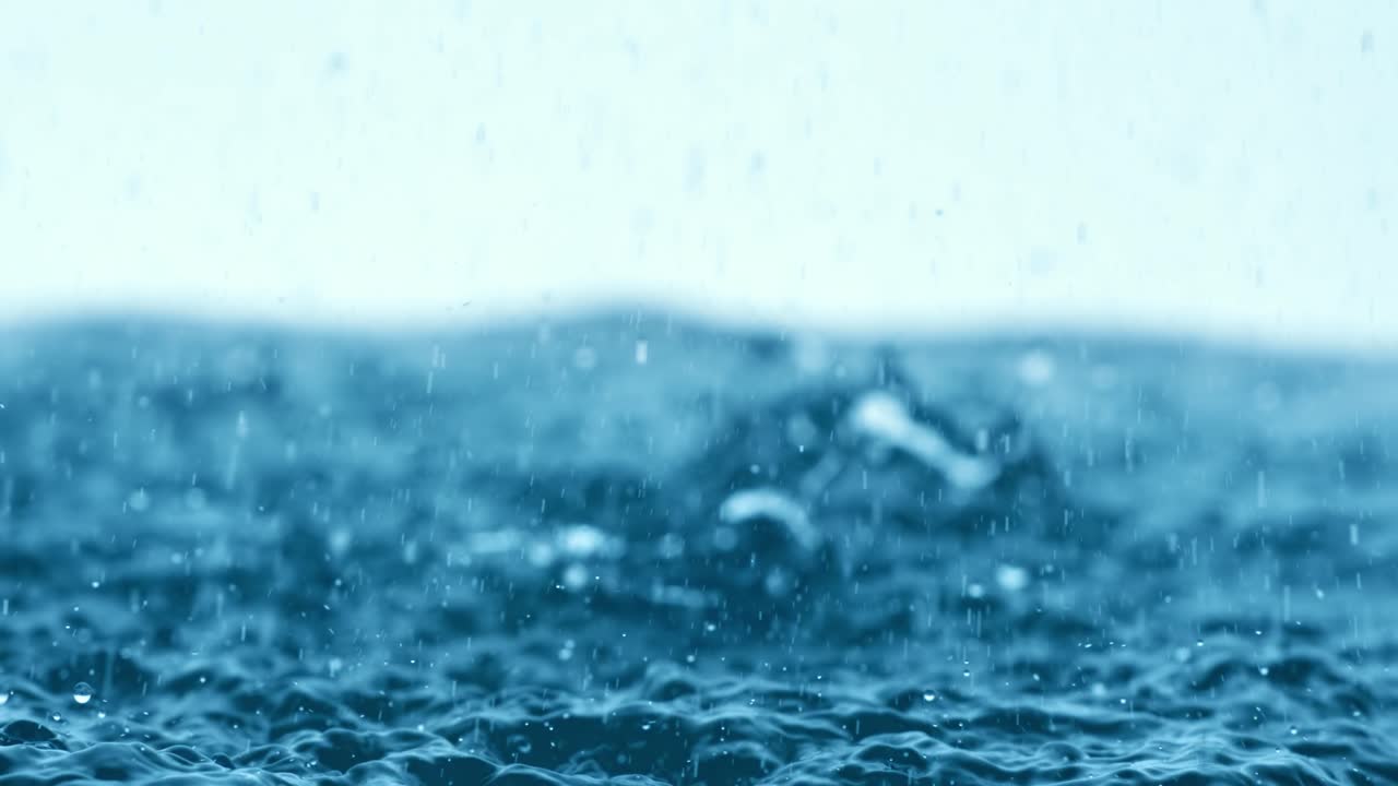 Rain water drops falling in super slow motion.