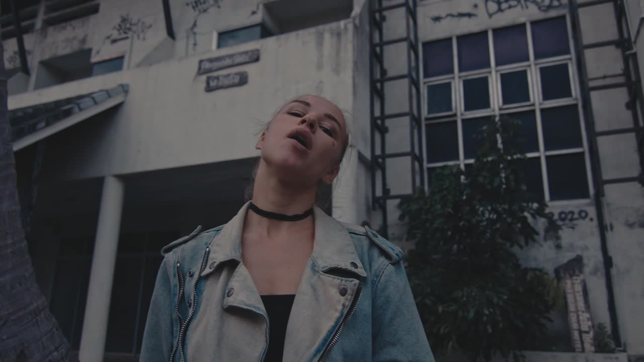 Young Woman Smoking Outside a Building