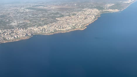 an airplane flies over the turkish city of antalya shortly after take-of