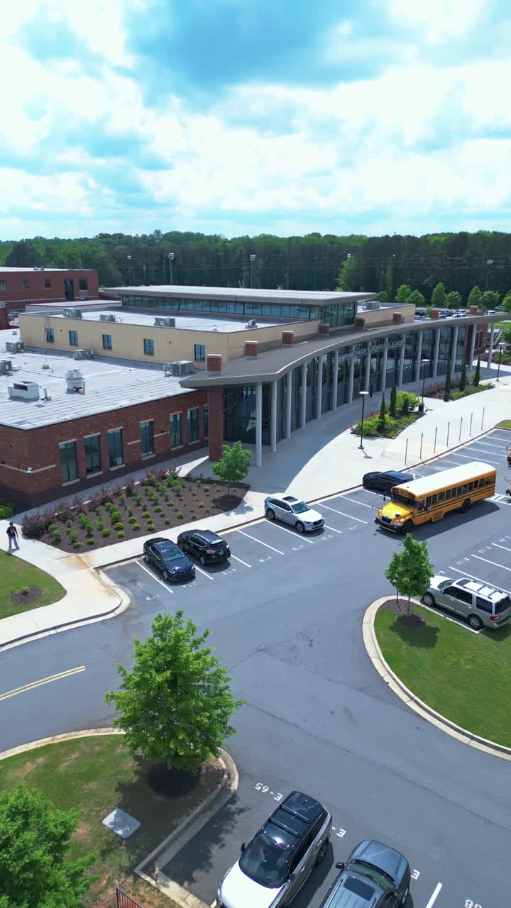 Aerial View Of Cobb Innovation and Technology Academy In Marietta, Georgia - Modern Architecture With Parking Lot. vertical, pullback shot