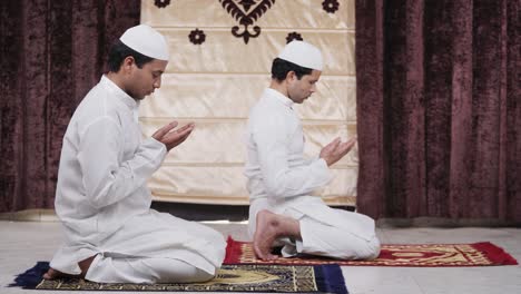 muslim men reading namaz and doing prayers at home