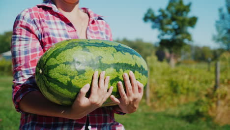 woman carrying large watermelon