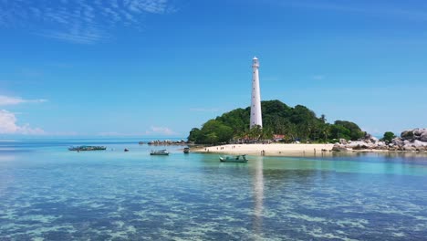 aerial of traditional indonesian boats anchored off the coast of lengkuas island in belitung on sunny day