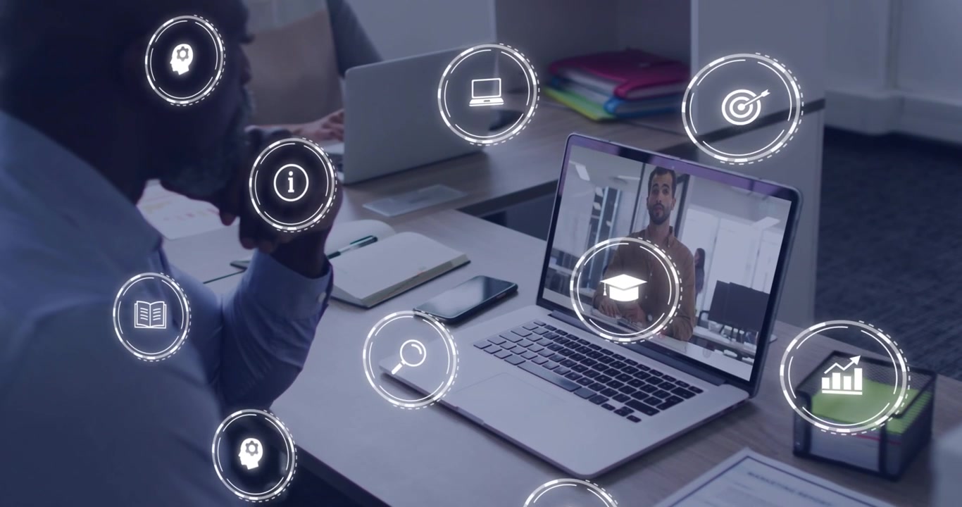 Mature man watching laptop, remote presenter speaking, icons multiplying across frame for business