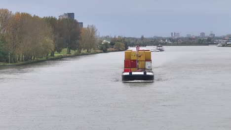 Wide-angled-aerial-footage-of-fully-loaded-cargo-vessel-sailing-onwards