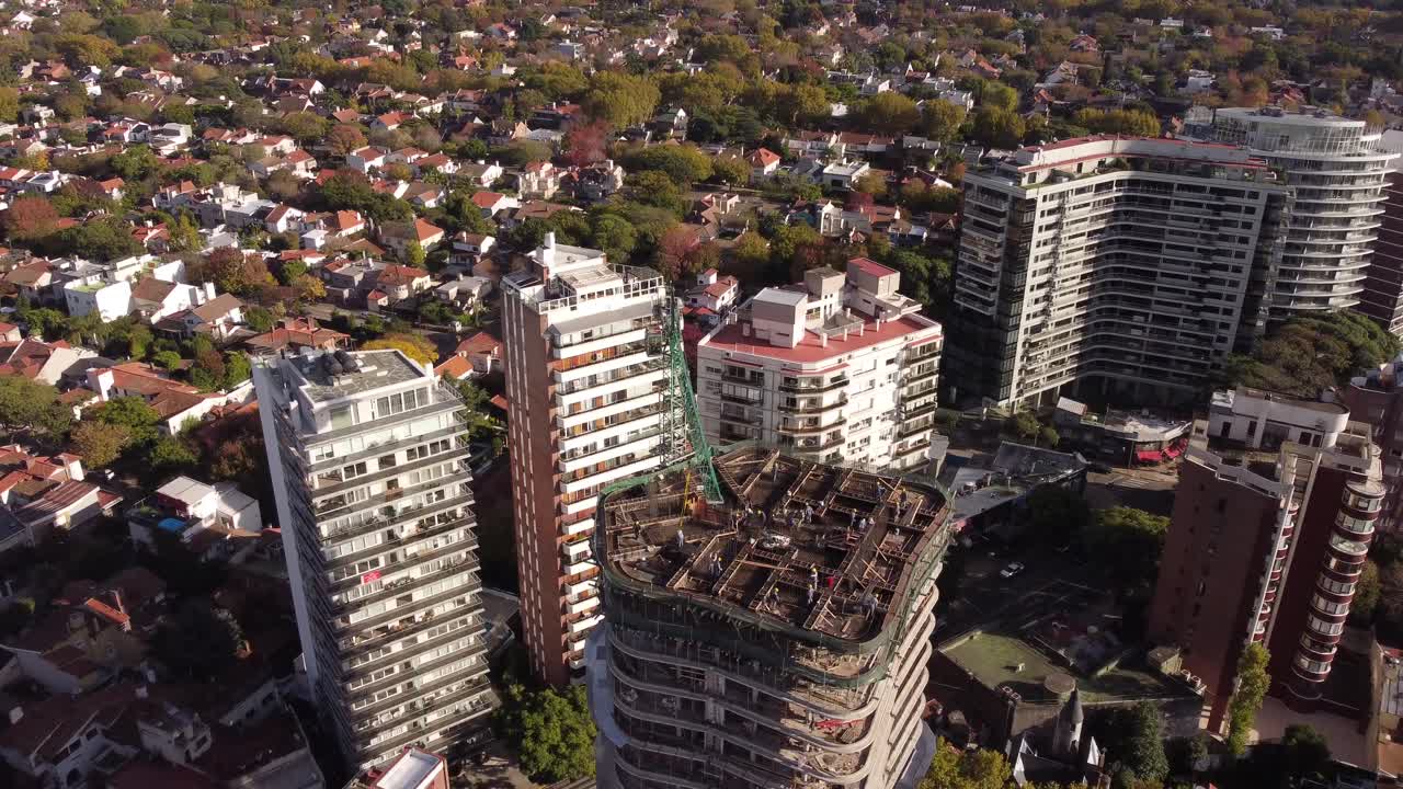 trabajadores del sitio de construcción en la parte superior del edificio con grúa torre, antena