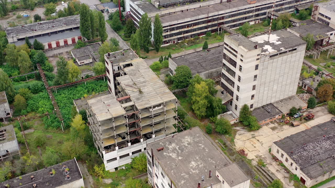 View from above of ruined and abandoned factory. Aerial view of industrial destroyed city buildings.
