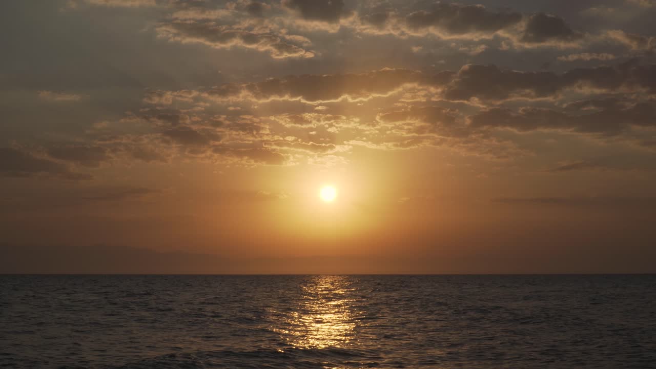 Golden hour view from a boat in the sea in Greece.
