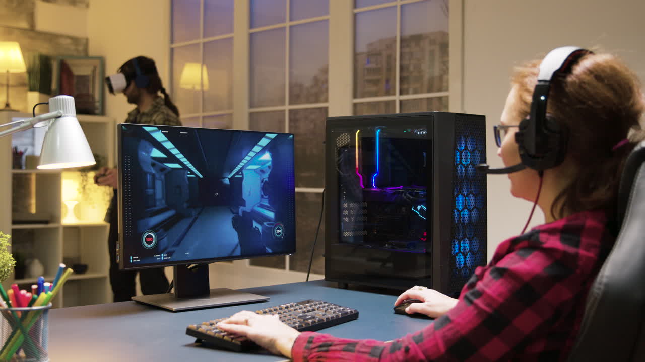 Gamers playing video games on computer and VR headset