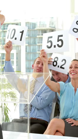 business people holding grade during meeting