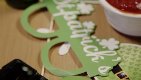 close up of irish novelties and props with snacks of tortilla chips and salsa at st patrick's day party