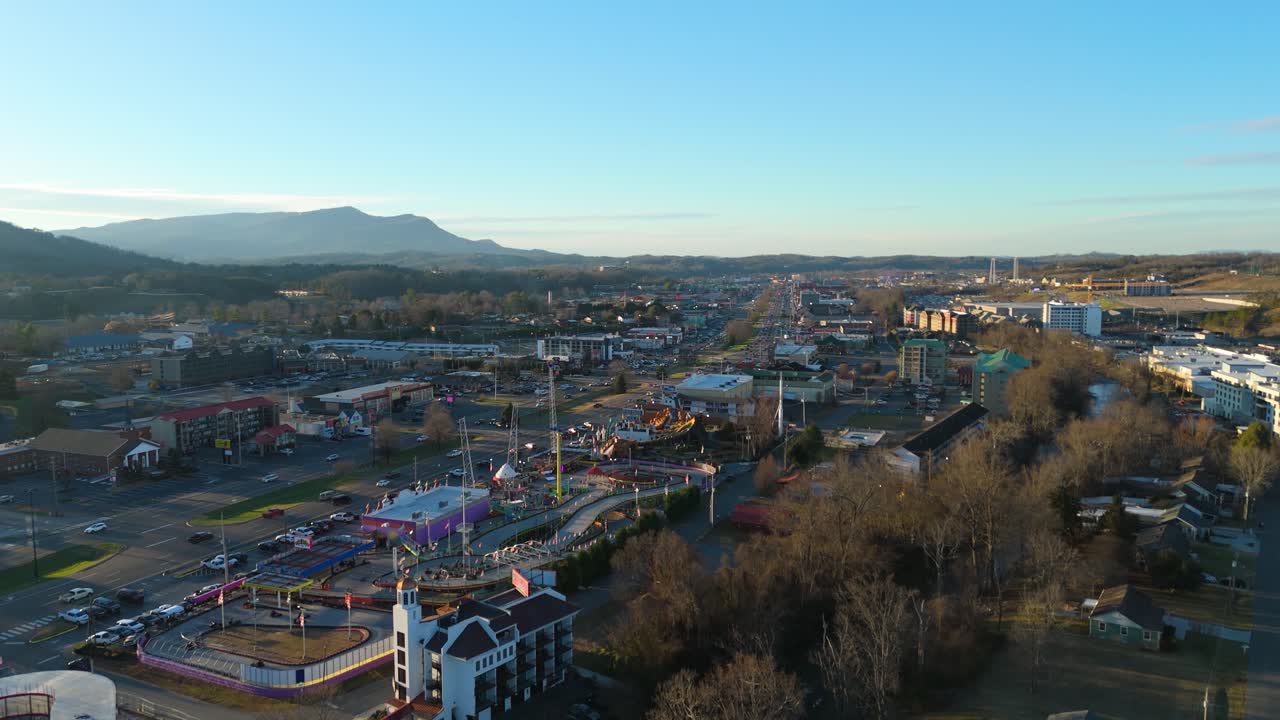 Piegon Forge, TN aerial push in over amusement parks at sunset.
