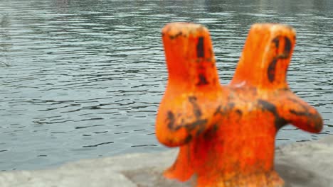 orange bollard on a quay