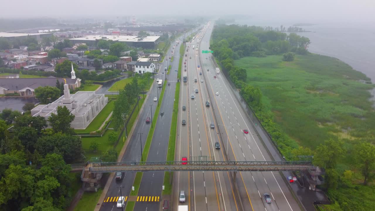 Aerial cityscape view over vehicles on a highway in Montréal, Canada, on a rainy day