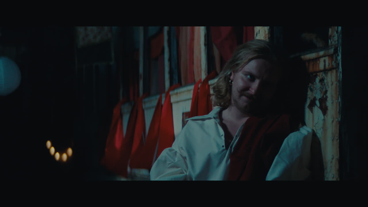 A man witch mustache in the empty gypsy circus camp at night