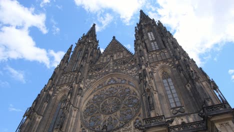 st vitus cathedral and historic prague castle buildings in gothic majesty st vitus cathedral rises above the surrounding castle buildings showcasing its detailed gothic architecture seen from behind the trees parallax shot