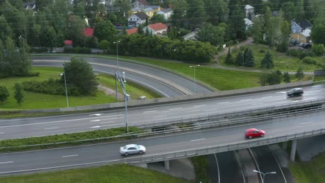 aerial pan up of a motorway along a suburban area in finland near helsinki