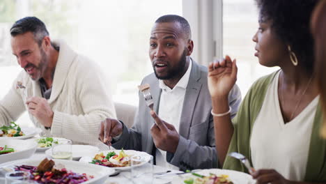 diverse and mature group of friends eating