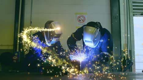 Animation-of-glowing-shooting-star-over-male-engineers-welding