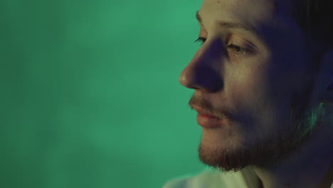 portrait of a man on a neon light colorful background. close-up.