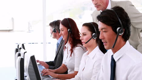 call centre agents working and talking on headsets