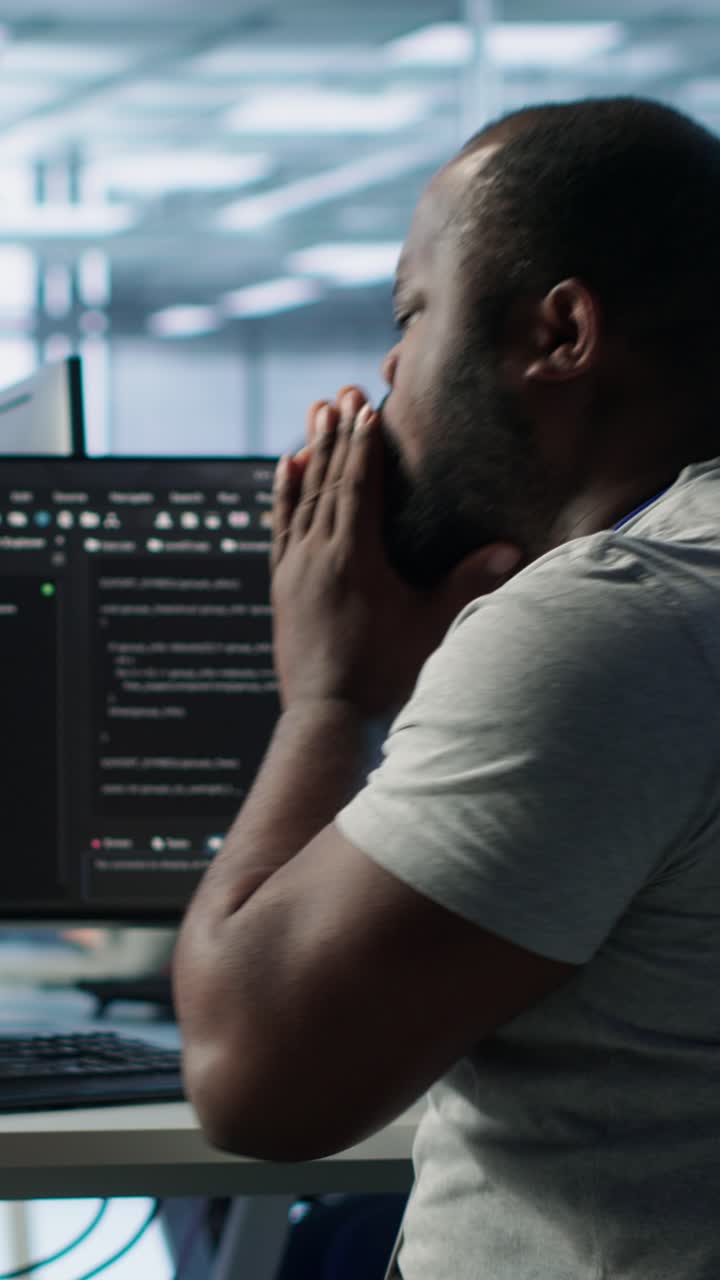 Stressed African American Programmer Working on Computer in Office