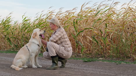 woman and dog in a cornfield