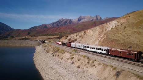 train stationed along deer creek reservoir in the fall of utah