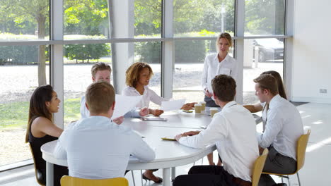 business team having meeting around table in modern office