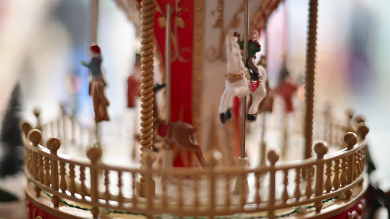 Close up of a miniature vintage carousel with decorative horses and ornate details