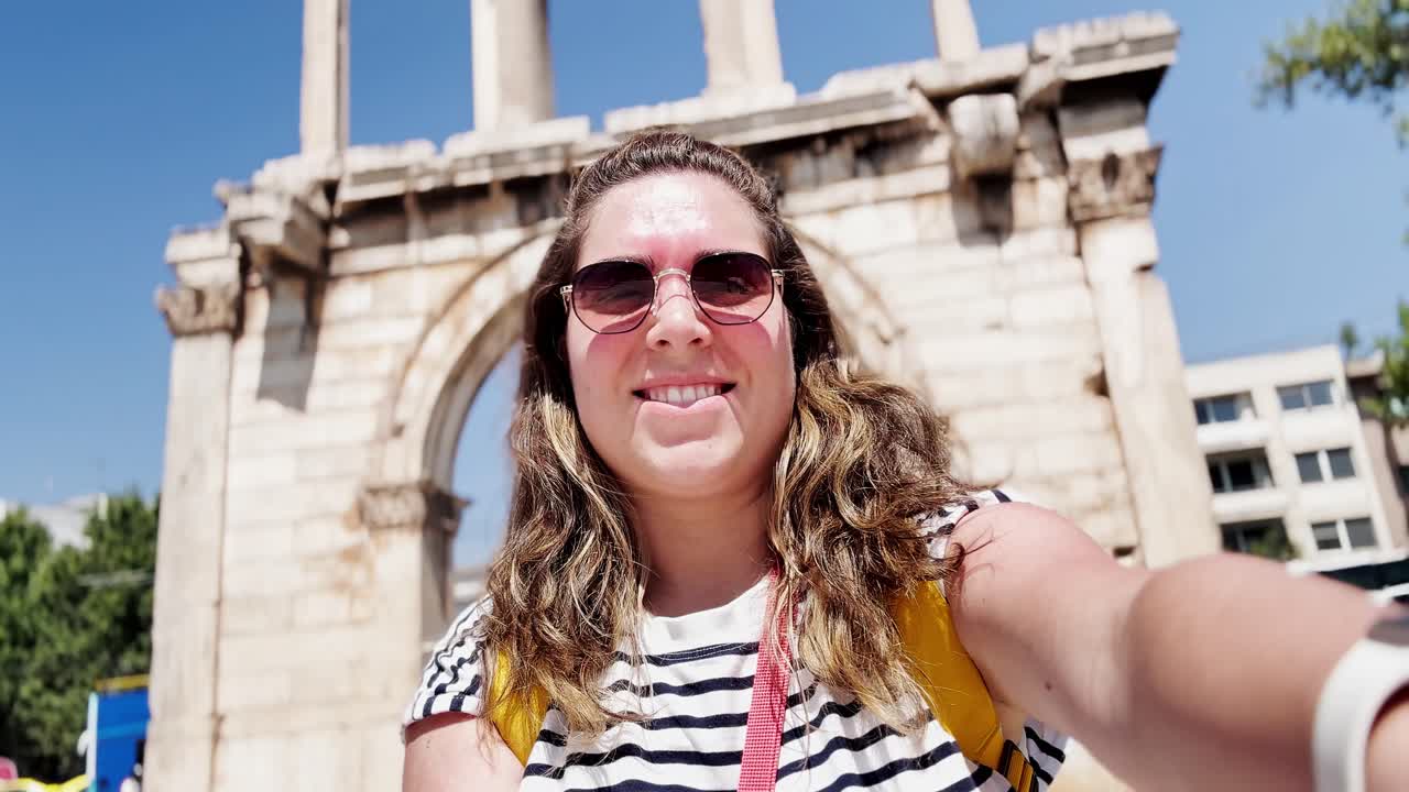 Happy Tourist Takes a Selfie at Hadrian's Arch in Athens, Greece
