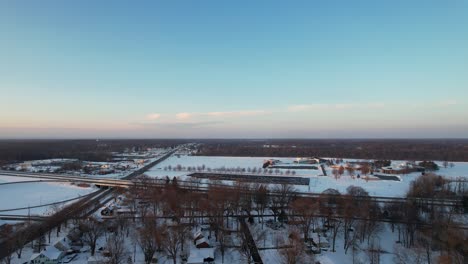 Aerial-drone-view-of-suburb-area-in-cold-winter-day-against-blue-sky