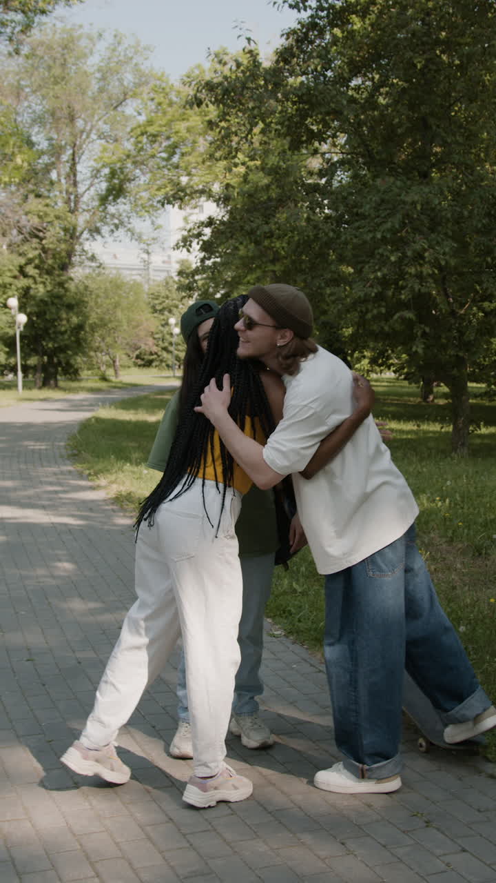 Friends hugging and talking in a park