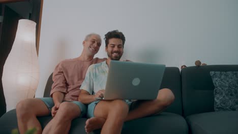gay couple watching something on laptop