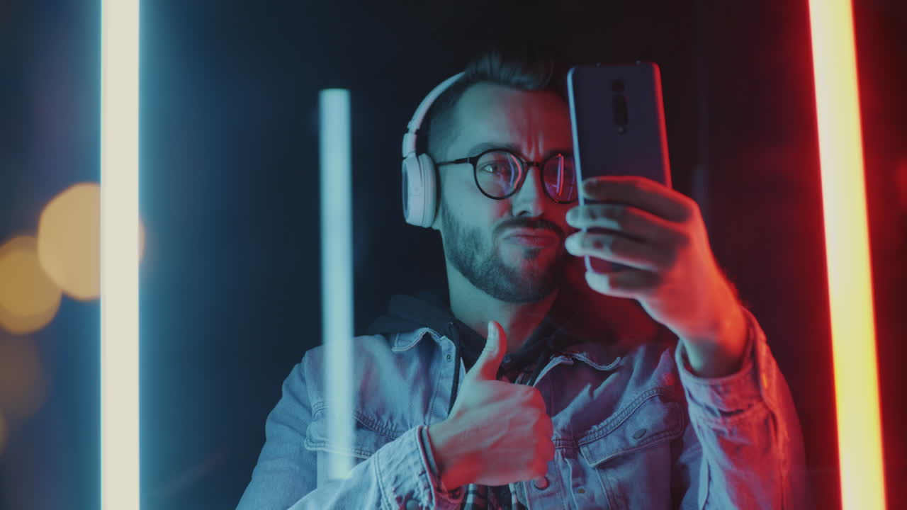 Man taking a selfie in neon light