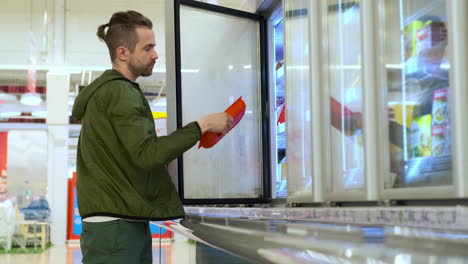 man shopping for frozen food in a supermarket