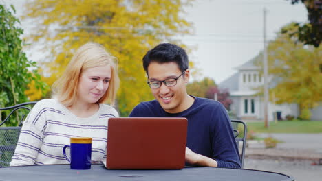 Students-Work-With-A-Laptop-At-The-Table-Of-A-Summer-Cafe-2