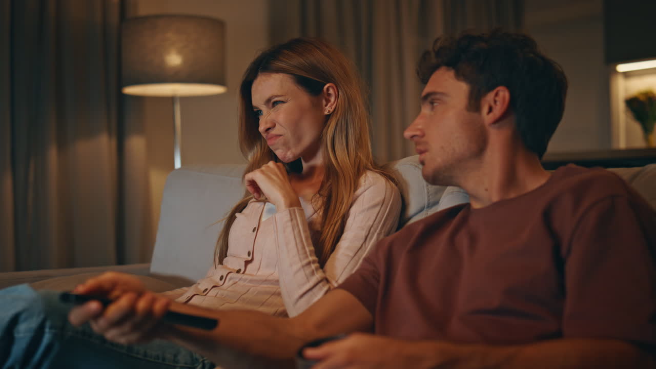 Relaxed family switching channels sitting at living room late evening closeup