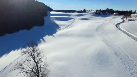 drone tracking shot of two cross country skiers on a sunny day