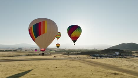 vibrant aerial footage of the northern california hot air balloon festival with mountains and hills in the background